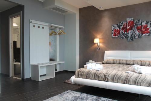 a bedroom with a white bed and a table at Hotel Mediterraneo in Roccella Ionica