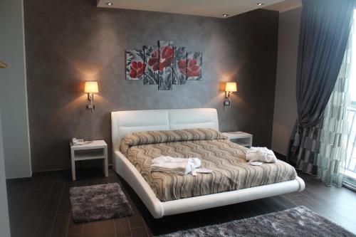 a bedroom with a bed with a dog laying on it at Hotel Mediterraneo in Roccella Ionica