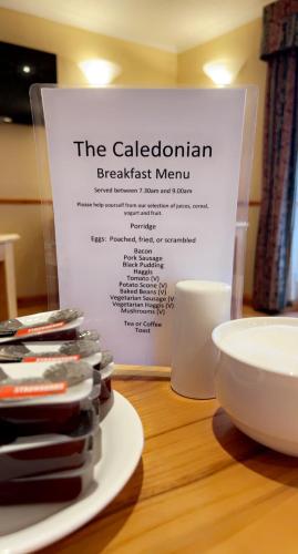 a sign for the caledonian breakfast menu on a table at The Caledonian in Portree