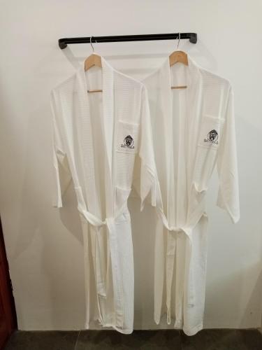 two white shirts are hanging on a rack at Bathala Resort in Panglao