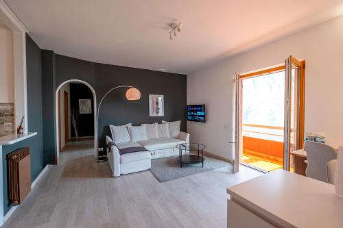 a living room with a white couch and a window at Happy Guest Apartments - Dolce Vista in Riva di Solto