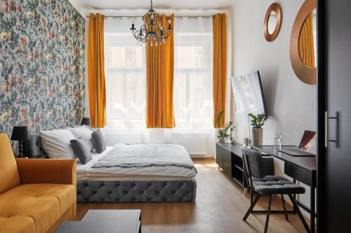 a bedroom with a bed and a desk at Designer Studio in New Town by Prague Days in Prague