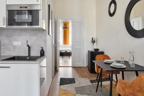 a kitchen with a sink and a table with chairs at Designer Studio in New Town by Prague Days in Prague