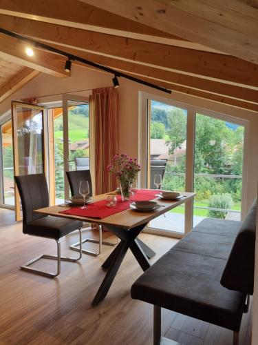 a dining room with a wooden table and chairs at Sunnefleackle -Haus Lingenhöl in Sonthofen
