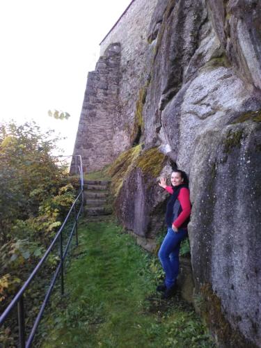 a woman standing next to a large rock at Urlaubspension Die Mühle in Schöllnach