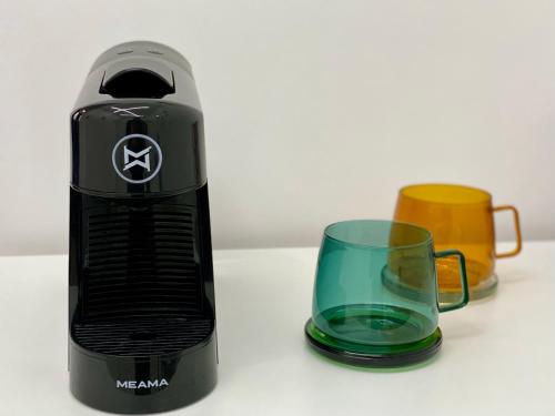 a blender and a glass mug on a table at Express Inn in Poti