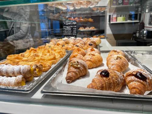 a bakery display case with various pastries and croissants at HappyHome Bilocale centro storico Rivarolo Canavese in Rivarolo Canavese