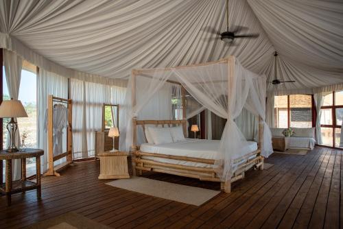 a bedroom with a canopy bed in a tent at Eco Del Mar in Pedernales