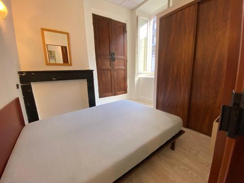 a small bedroom with a bed and a window at Boost Your Immo Ramond Barèges PM26 in Barèges
