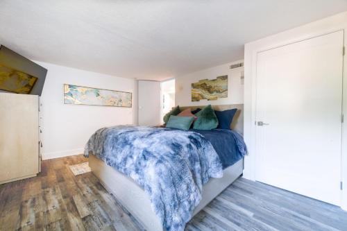 a bedroom with a bed with a blue comforter at Loki's Kingdom in Rockaway Beach