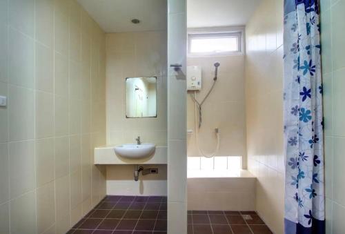 a bathroom with a sink and a shower at Kata Beach Guesthouse in Kata Beach