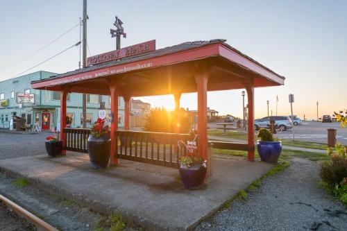 a bus stop with potted plants in front of it at Loki's Kingdom in Rockaway Beach