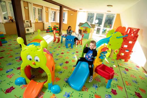 a group of children playing in a room with toys at Chata Belez in Dolný Kubín