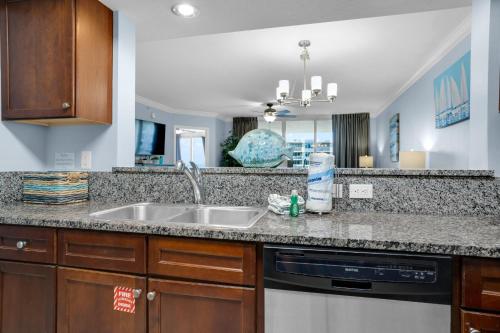 a kitchen with a sink and a dishwasher at Heron 507- A Wave From It All in Fort Walton Beach