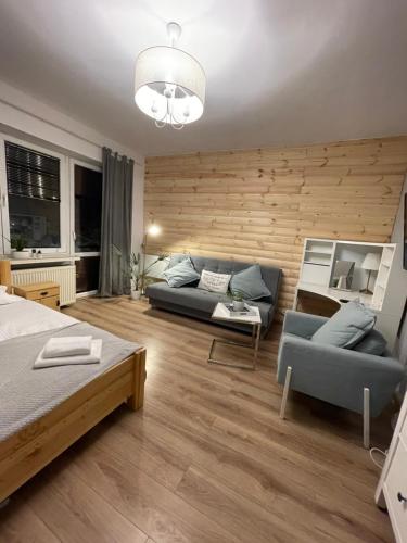 a living room with a couch and a couch and a table at EXPO KRUPÓWKI 60 APARTMENT in Zakopane