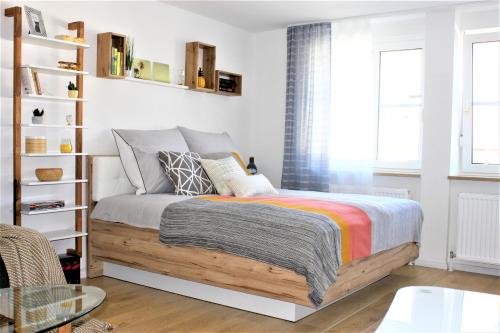 a bedroom with a bed and a book shelf at Appartement Hauptbahnhof in Nuremberg