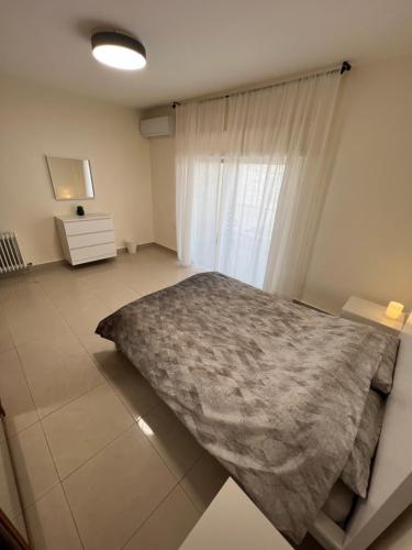 a bedroom with a bed and a window at Bedouin Break Condo - In the Heart of Amman in Amman
