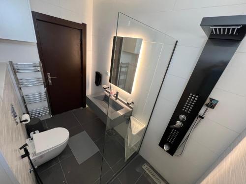 a bathroom with a toilet and a sink and a phone at Bedouin Break Condo - In the Heart of Amman in Amman