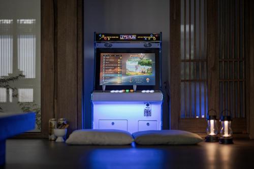 a video game machine in a dark room with aperature at Present Stay in Jeonju