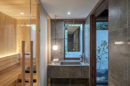 a bathroom with a sink and a mirror at Present Stay in Jeonju