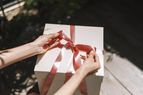 a person tying a bow on a gift box at Present Stay in Jeonju