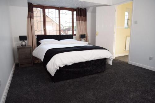 a bedroom with a large bed and a window at The Kyoto House - Four Spacious Cosy Bedrooms I Netflix & Large Rooms in Derby
