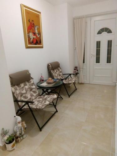a living room with two chairs and a table at Apartment Vila MM Srce in Vrdnik