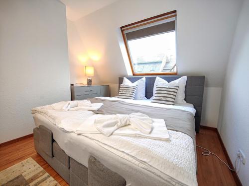 a bedroom with a large bed with a window at YourFavoriteBed 100m2 Designwohnung mit Vollausstattung in Plauen