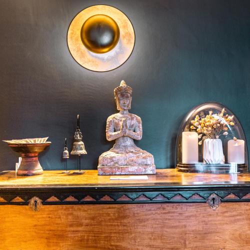 a altar with a statue on a table with candles at La Maison Pavie in Dinan