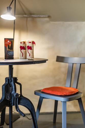 a table with two stools and a table with at La Maison Pavie in Dinan