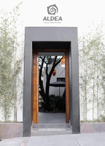 a door to a building with a tree in it at VILLA HUIZACHE ALBERCA PRIVADA+EXCLUSIVIDAD+LUJO in San Martín de las Pirámides