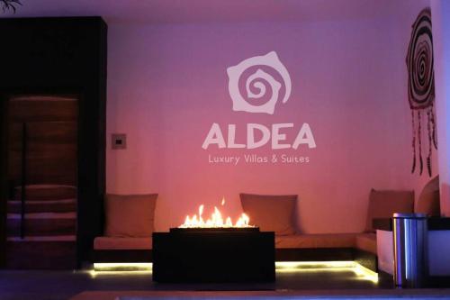 a living room with a fireplace with a purple wall at VILLA HUIZACHE ALBERCA PRIVADA+EXCLUSIVIDAD+LUJO in San Martín de las Pirámides