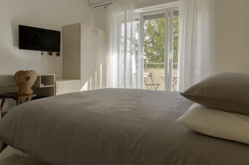 um quarto branco com uma cama grande e uma janela em Bragadin75 In Vaticano em Roma