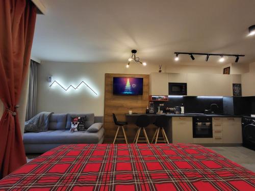 a living room with a couch a table and a kitchen at Pinewood ANG luxurious apartment A43, Borovets Gardens in Borovets