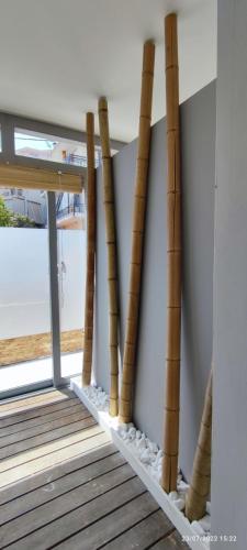 a group of bamboo poles leaning against a wall at LEFKAS CITY APARTMENTS & Suites in Lefkada Town