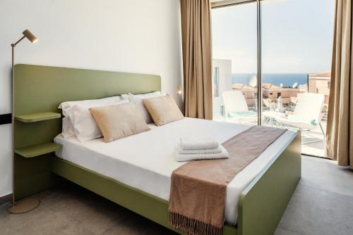 a bedroom with a bed with a view of the ocean at Villa Eden in Adeje