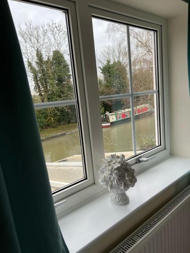 a window with a vase sitting on a window sill at Canalside B and B in Yelvertoft