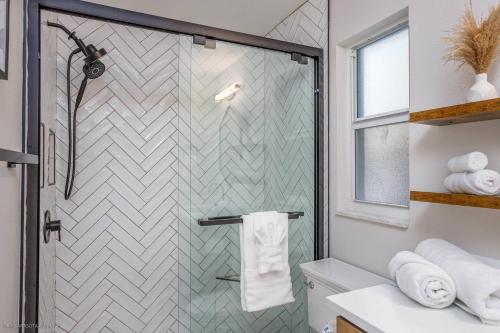 a bathroom with a shower with a glass door at Avenida Sanctuary in Siesta Key