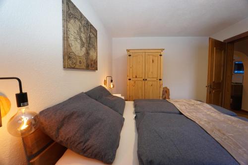 a bedroom with a bed with pillows on it at Apart Lisa in Huben