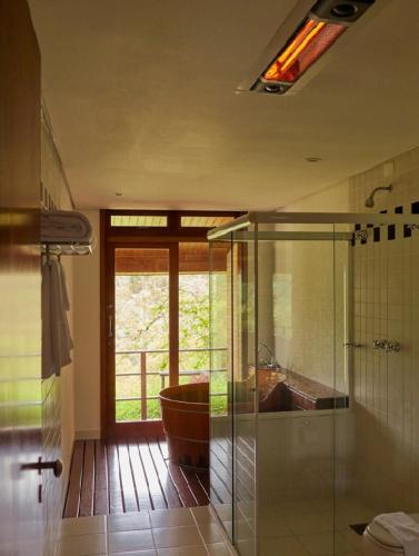a bathroom with a glass shower and a sink at Pousada do Cedro in Santo Antônio do Pinhal