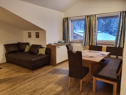 a living room with a table and a couch at Saumerhof in Schladming