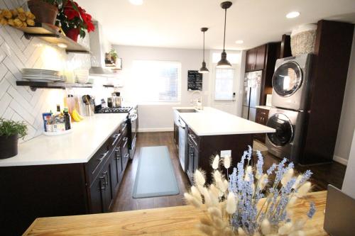 a kitchen with black cabinets and a white counter top at Capitol Hill Adj Home with Parking and Easy Access to Downtown in Washington, D.C.