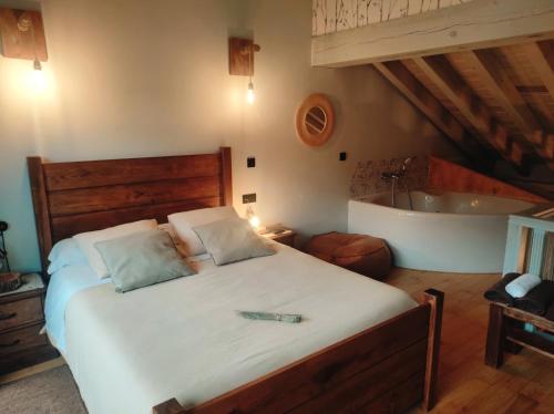 a bedroom with a bed and a bath tub at La Galiana loft nature in Casarejos