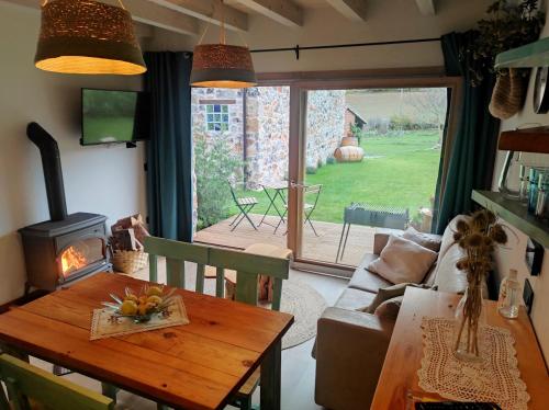 a living room with a table and a wood stove at La Galiana loft nature in Casarejos