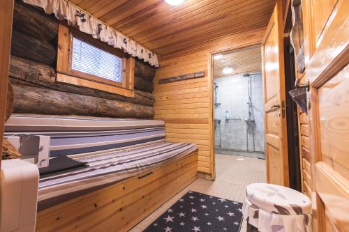 a sauna in a log cabin with a window at Hellevi in Levi