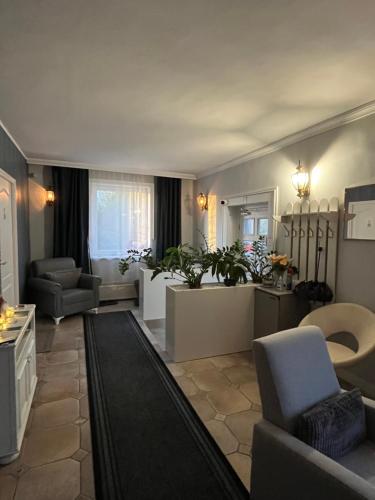 a large living room with a couch and chairs at Jager Guesthouse in Sopron