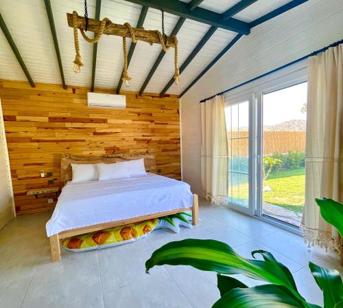 a bedroom with a bed and a large window at Bi Datça in Datca
