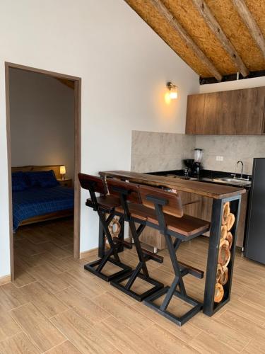 a kitchen with a wooden table and a counter top at Maravilloso chalet en la zona colonial (303) in Zipaquirá