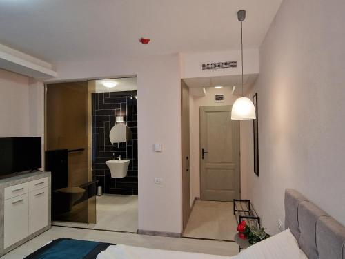 a living room with a door to a bathroom at Art's Luxury Boutique Hotel in Oradea