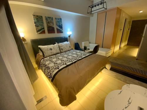 a bedroom with a large bed in a room at The Haven at One Eastwood Tower 1 in Manila